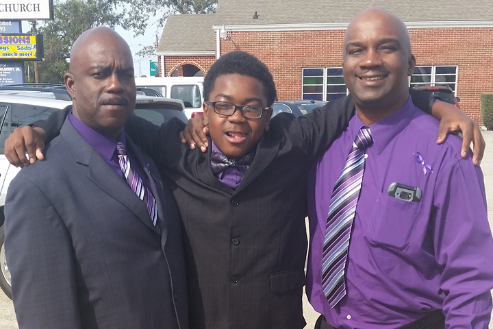 Pancreatic cancer survivor Cedric Robins Sr., his son, and another family member