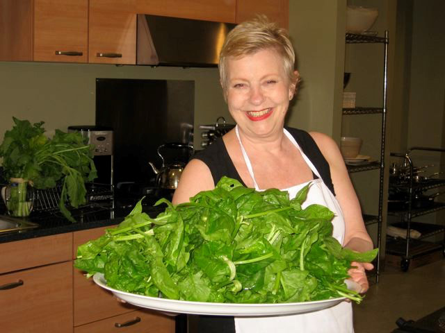Ann Ogden holds a platter of fresh spinach for patients. Nutritious food is key for patients after a Whipple procedure.