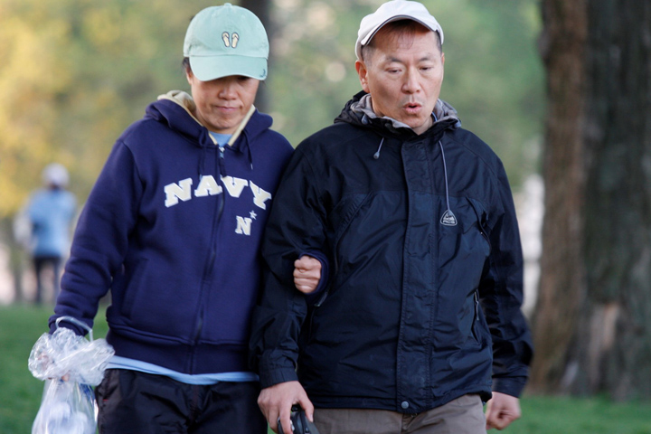 Older couple in navy blue walking for exercise