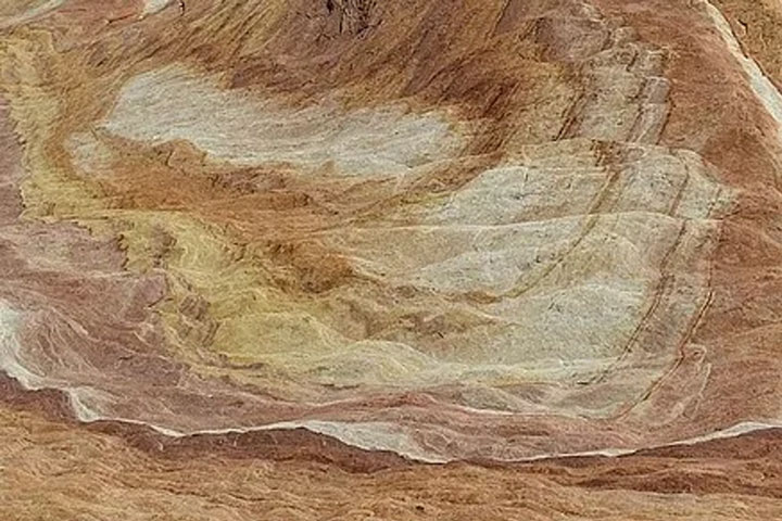 Rock layers in pink, white, light brown, and yellow
