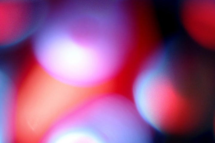 Abstract image of round and oval shapes in reds, pinks, whites, and light blues