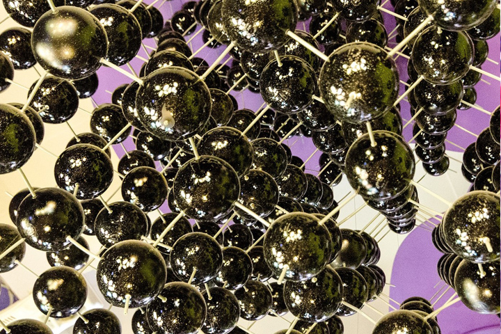 metal balls connected with thin sticks on a purple and white background