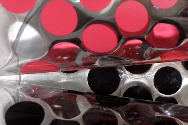 red tops and black tops of new beakers against a silver background