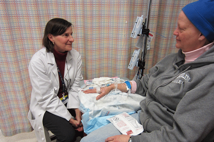 Oncology nurse and chemo patient talking