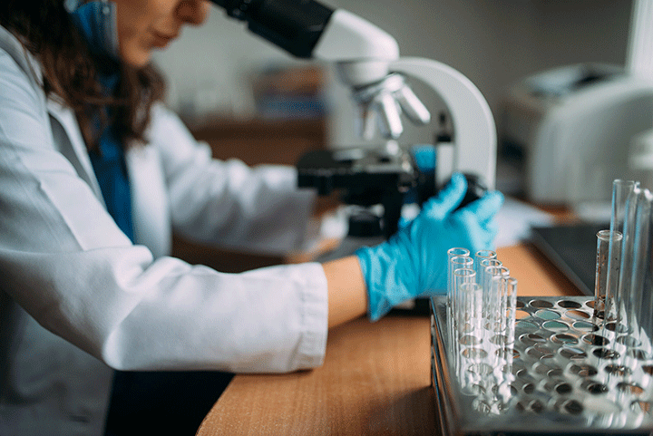 doctor looking in microscope