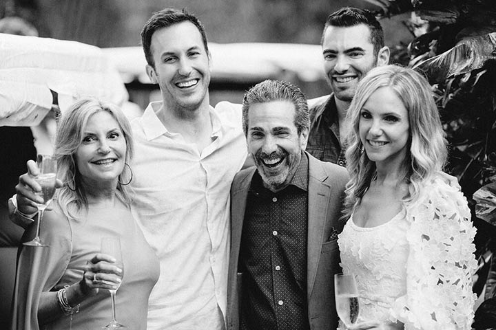 a black and white photo of a family of five, three men in the center and two women--one on either side of the men